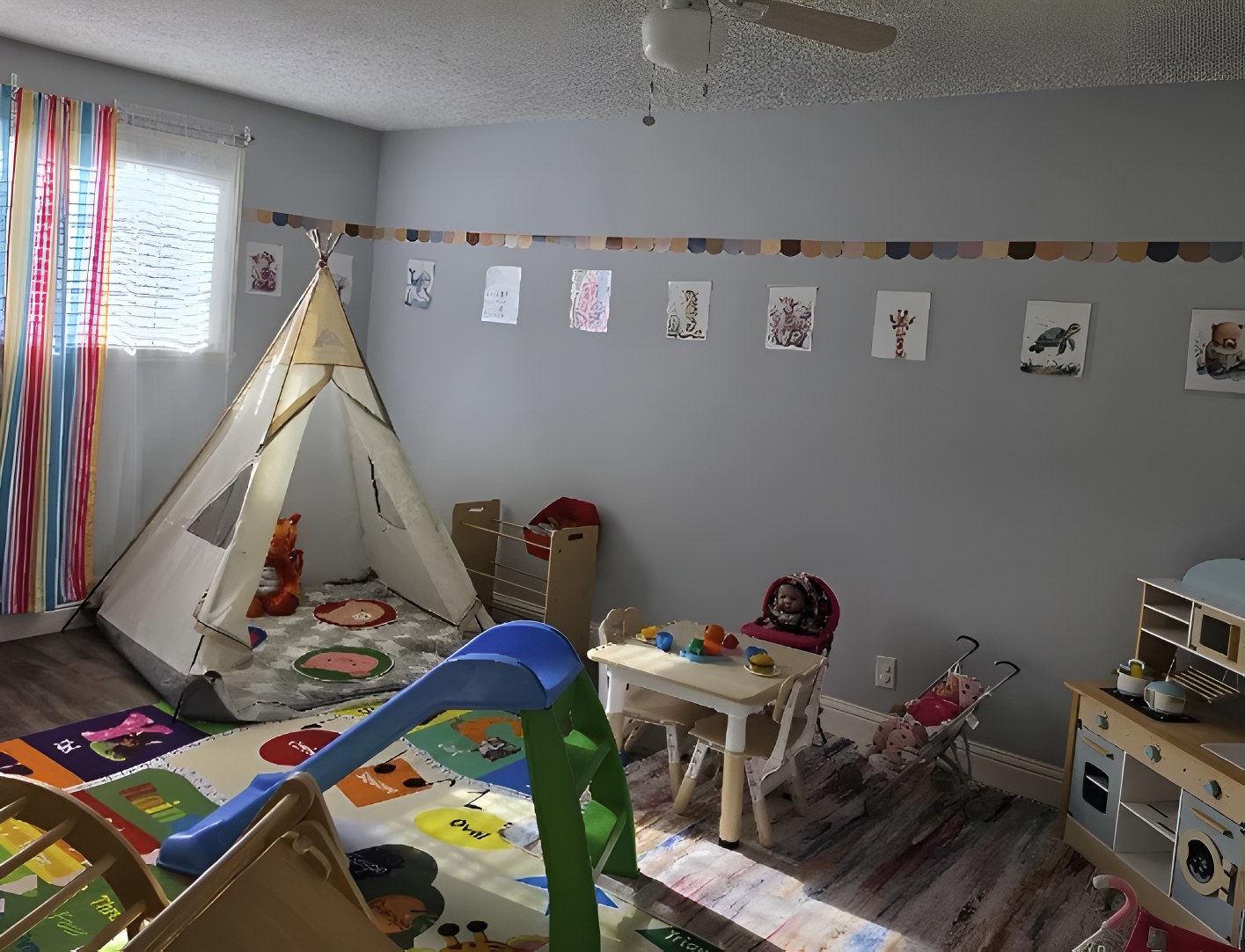 Playroom with reading tent, play kitchen and toddler table